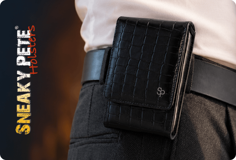 Close-up of a black alligator-embossed leather holster clipped to a belt